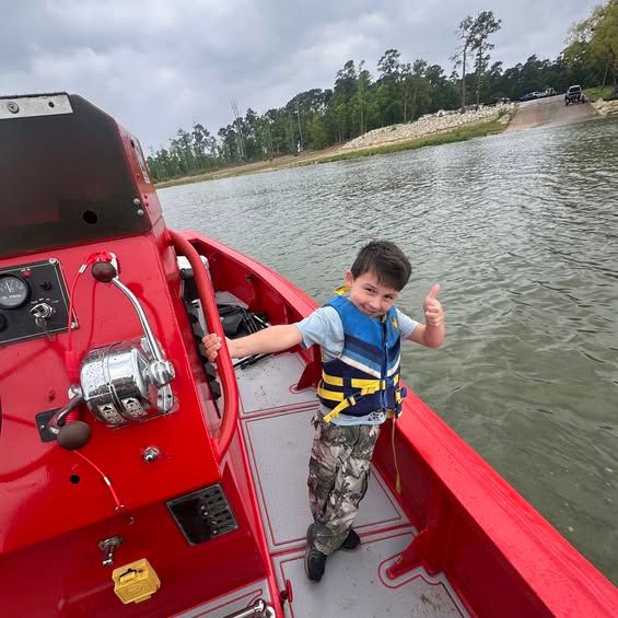 A young boater aboard the red TowBoatUS vessel out on Lake Fork Reservoir.