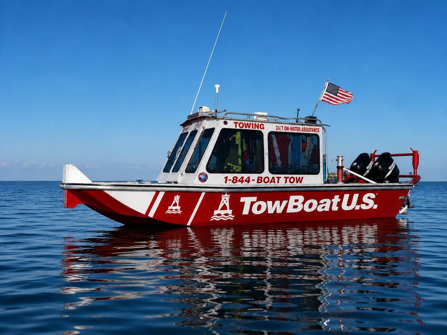 TowBoatUS Lake Fork's towing vessel on the water, company branding and phone number across the hull.